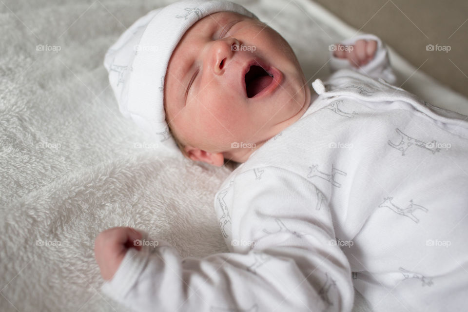 High angle view of baby yawing