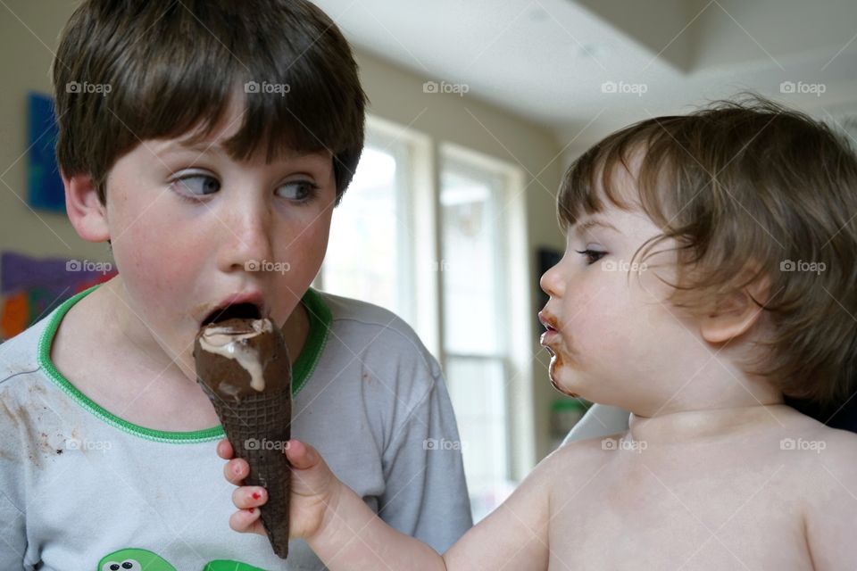 Children Sharing An Ice Cream Cone