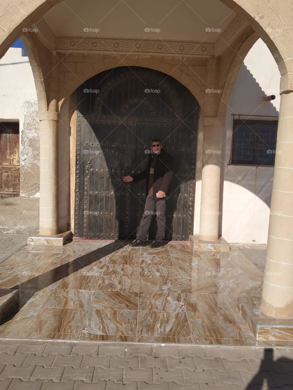Im standing near an ancient moroccan door at essaouira in Morocco.