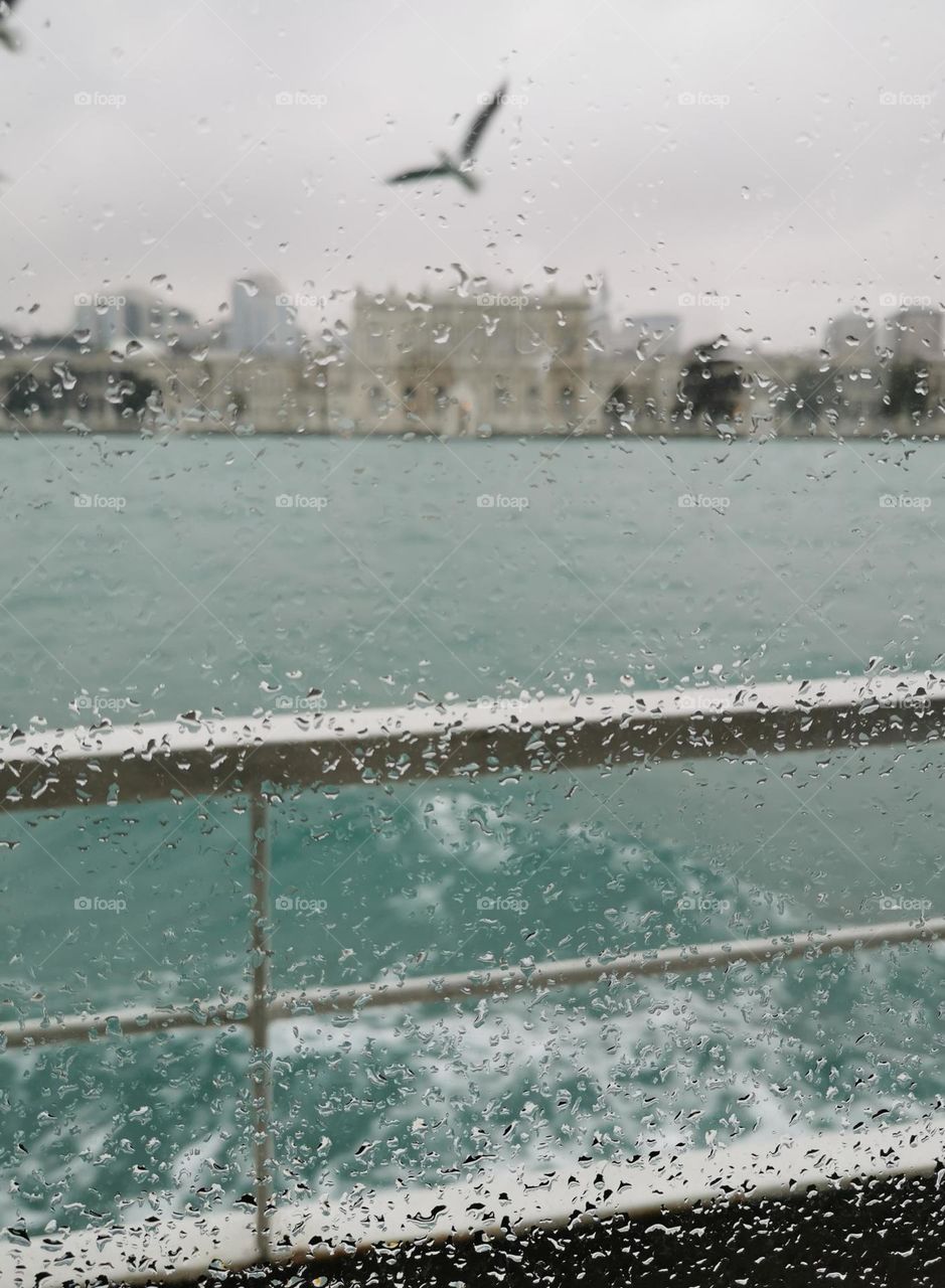 View from the window of the ship during a sailing along the Bosphorus in the rain