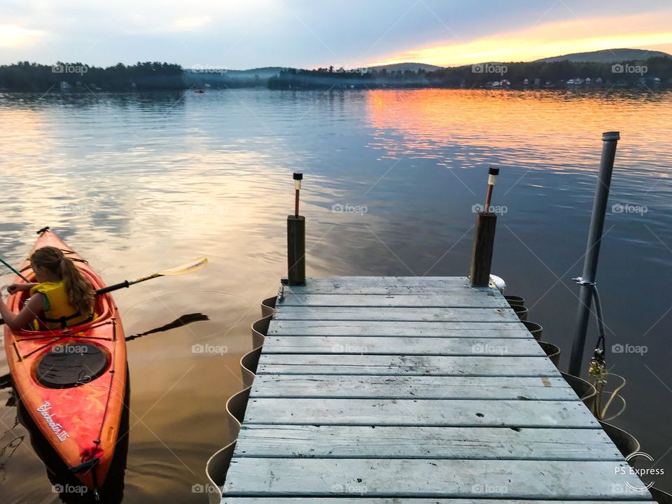 Kayak fun on lake in sunset evening peaceful relaxation