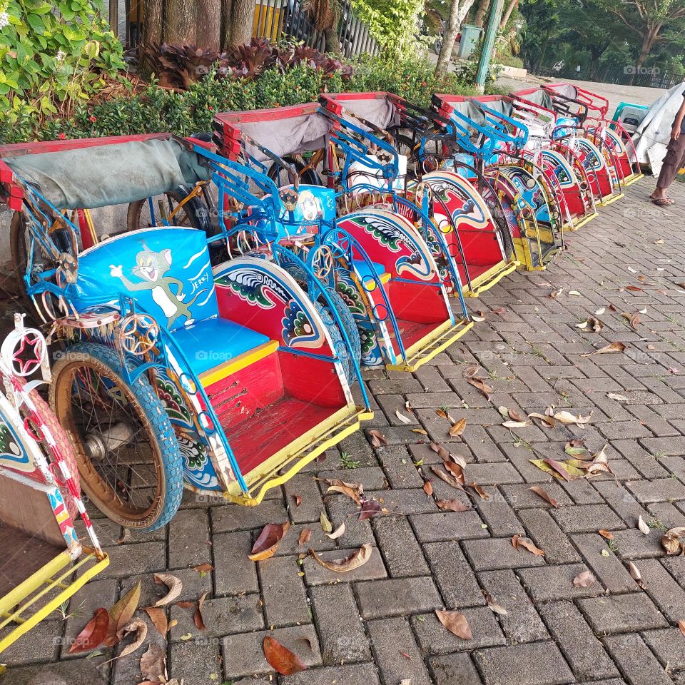 neatly parked pedicab in the playground