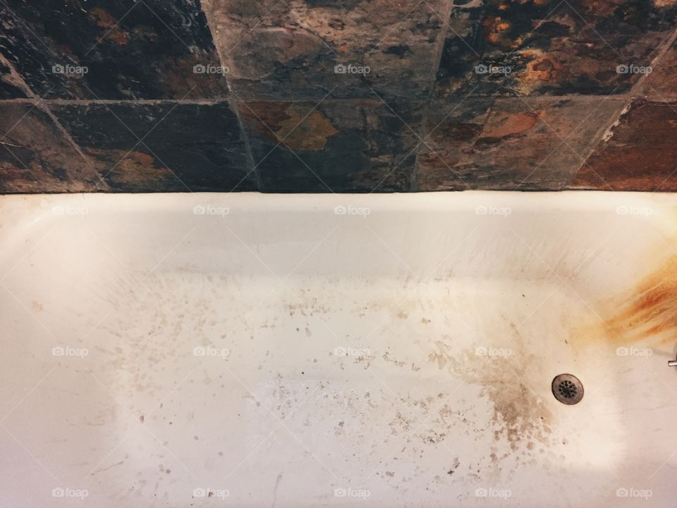 Bathtub with rust and lime scale