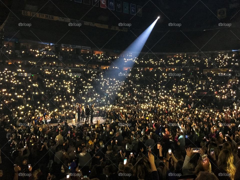 Large Music Concert with Lit Up Phones in the Crowd