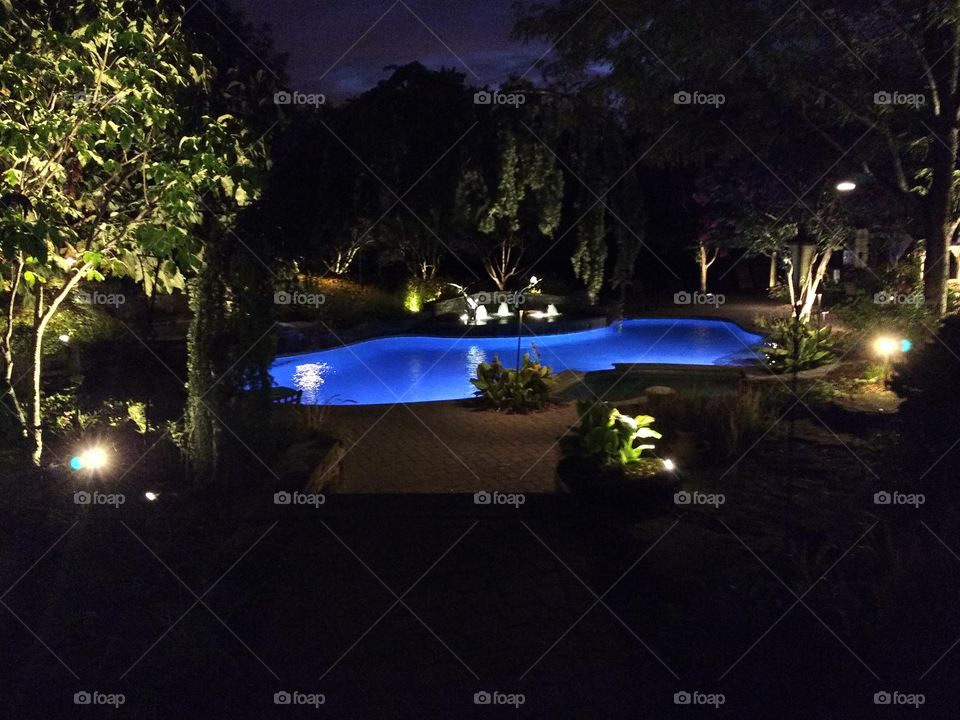 glowing blue pool at night