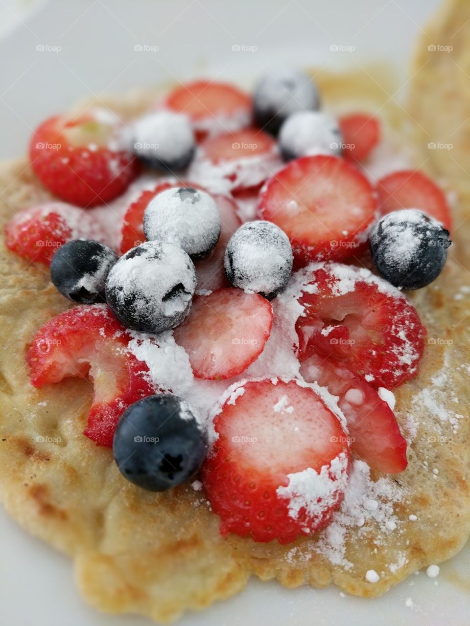 Pancake with strawberries and blue berries