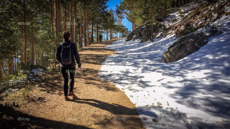 Hiking following the snowy path 