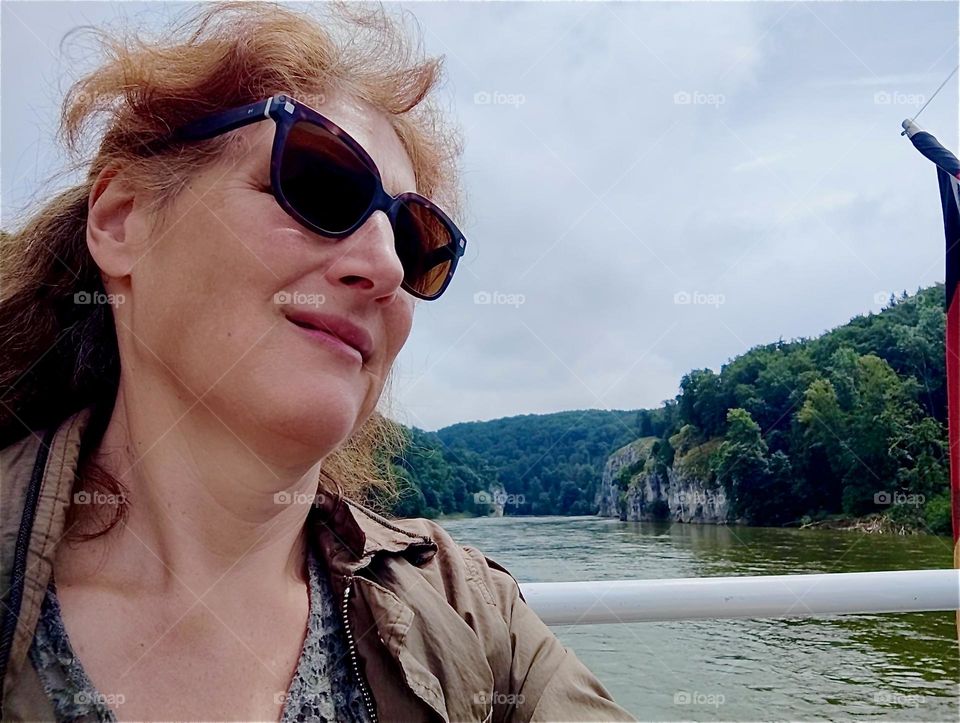 This lady travels on a “Zille”, an old style row boat on the “Danube” between “Kelheim” and the “Weltenburg Abbey” that sits on a peninsula at the “Donaudurchbruch” or “Danube Gorge” that forms a half loop around it. 2024. Hypnotic Productions