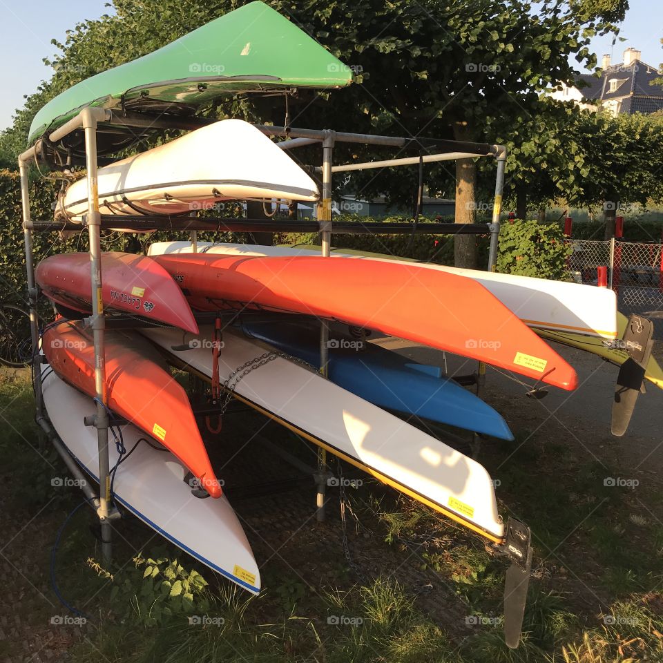 Colorful kayaks in metal rack