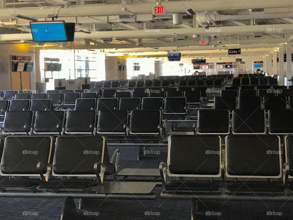 Empty airport terminal with many empty chairs 