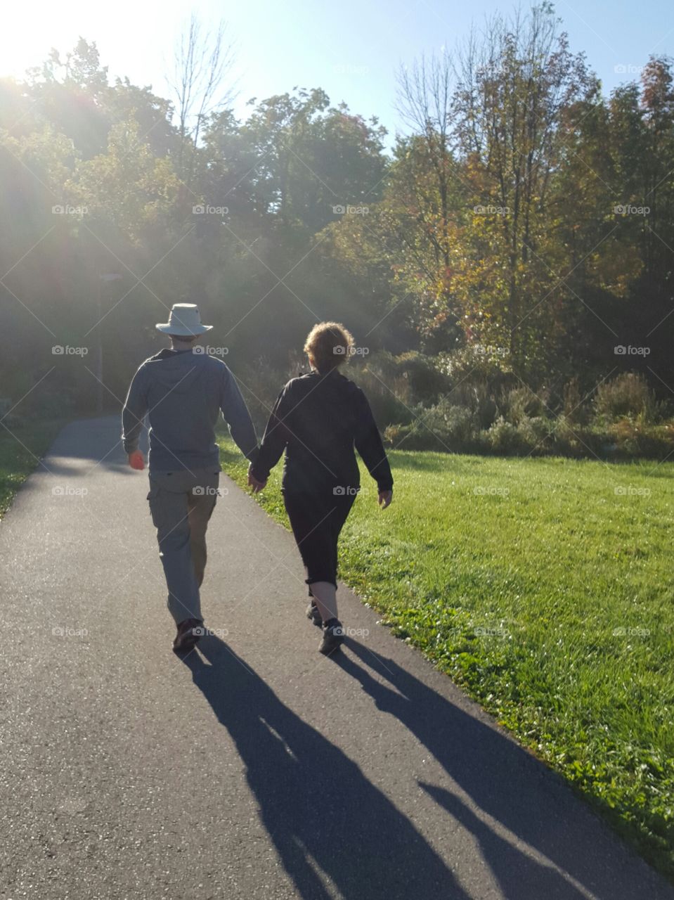 Rear view of couple holding hand