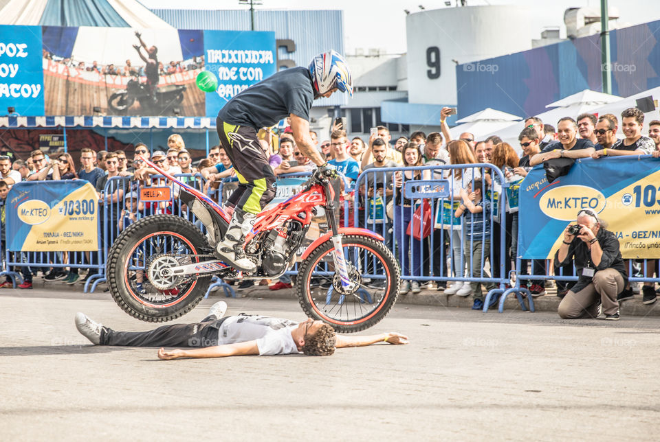 Doing Acrobatics With Quad Bike Terrain Vehicle In Front Of Crowd
