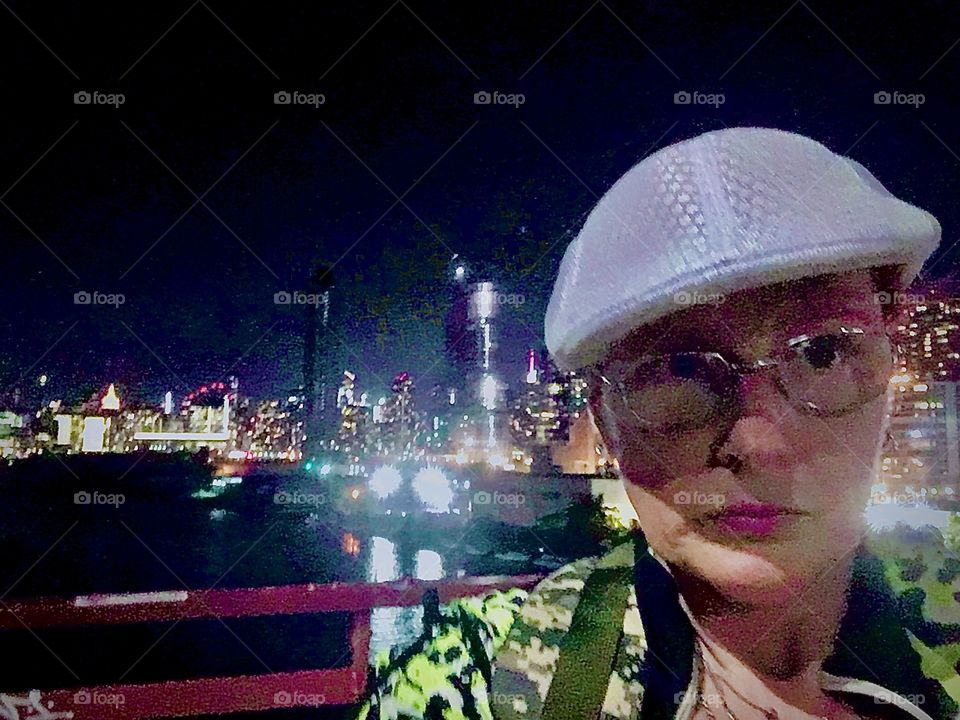 Self portrait standing on the Pulaski Bridge against Long Island City, Queens, New York and the waters of the East River at Newtown Creek in the background. Photo October 2020. Hypnotic Productions