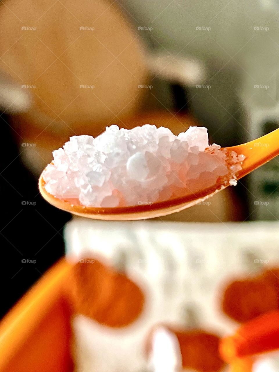 Sea salt shot against orange background of pedicure salon