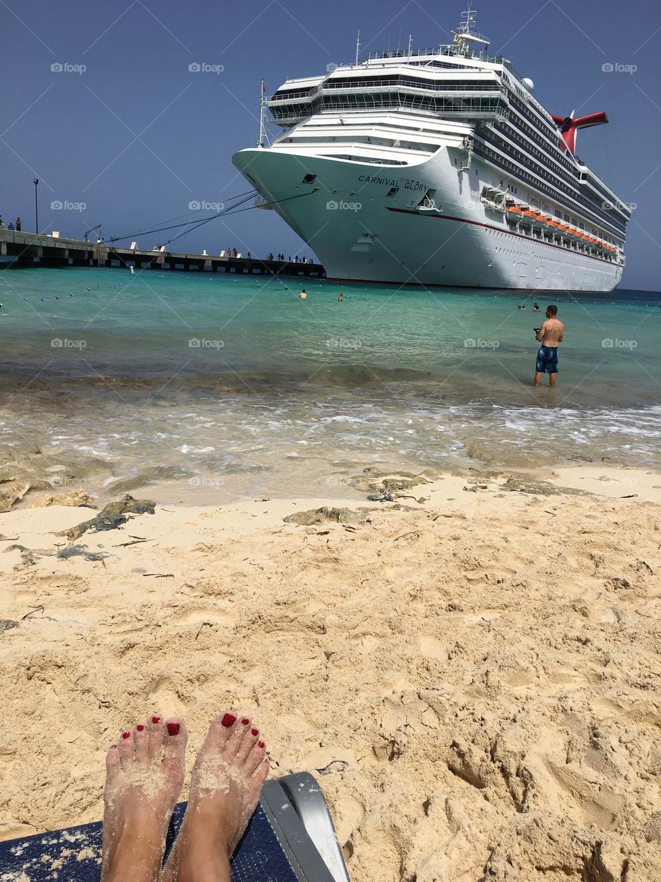 The feeling of sand in your toes while relaxing on the beach on a tropical Caribbean island.