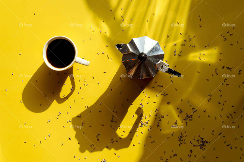 Business working morning with cup of hot coffee, french press, lavender flowers on yellow background close up. Top view, copy space, flat lay, mockup.