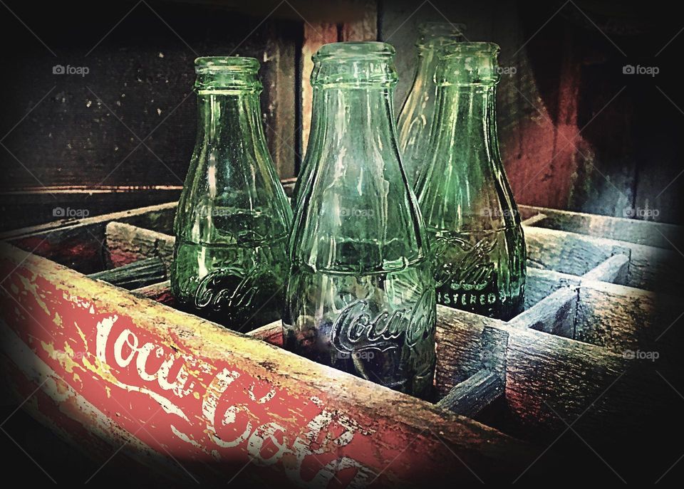 Vintage bottles in an antique crate.