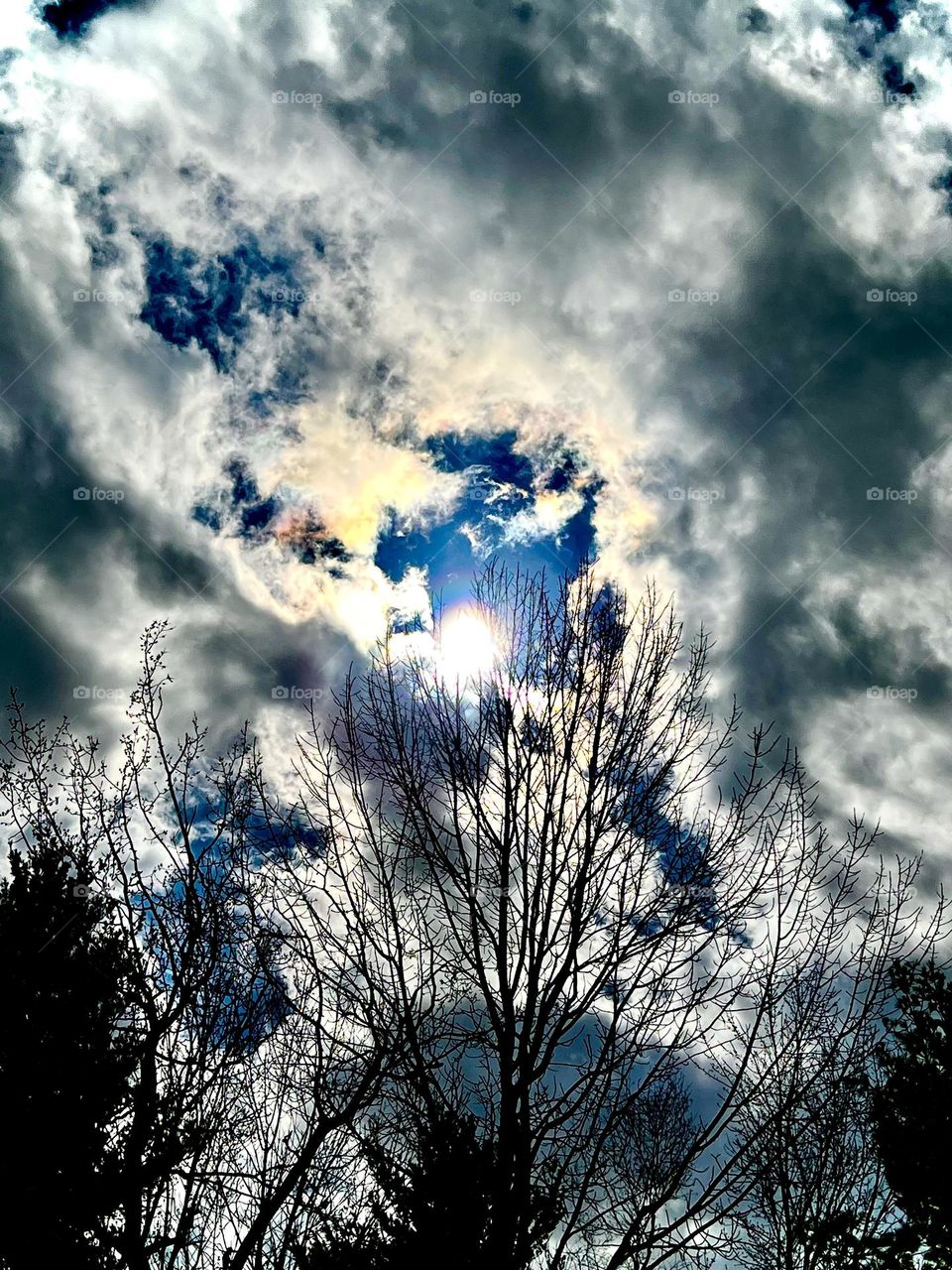 Storm clouds part for the sun to shine through in Spring.
