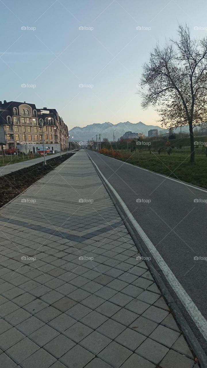 Evening landscape Building mountains and a road to far away