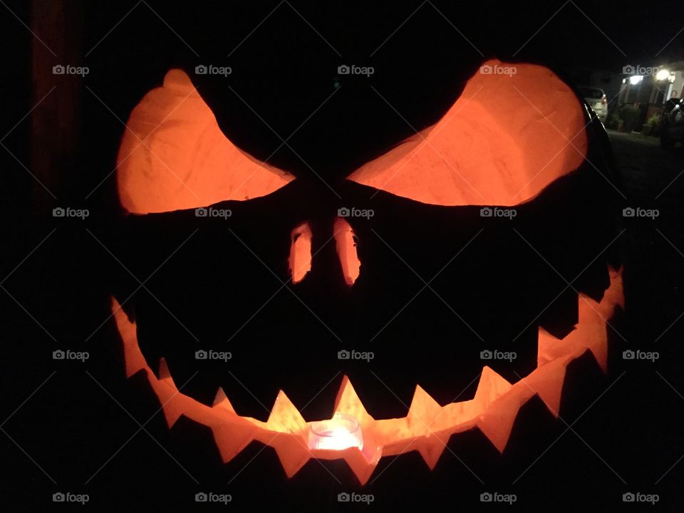 Big face of Halloween. Big face of Halloween made of a pumpkin with a candle inside
