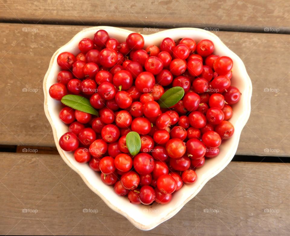 Lingonberries in heart shape bowl