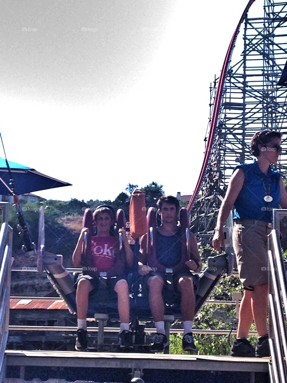 Father and son on ride in amusement park