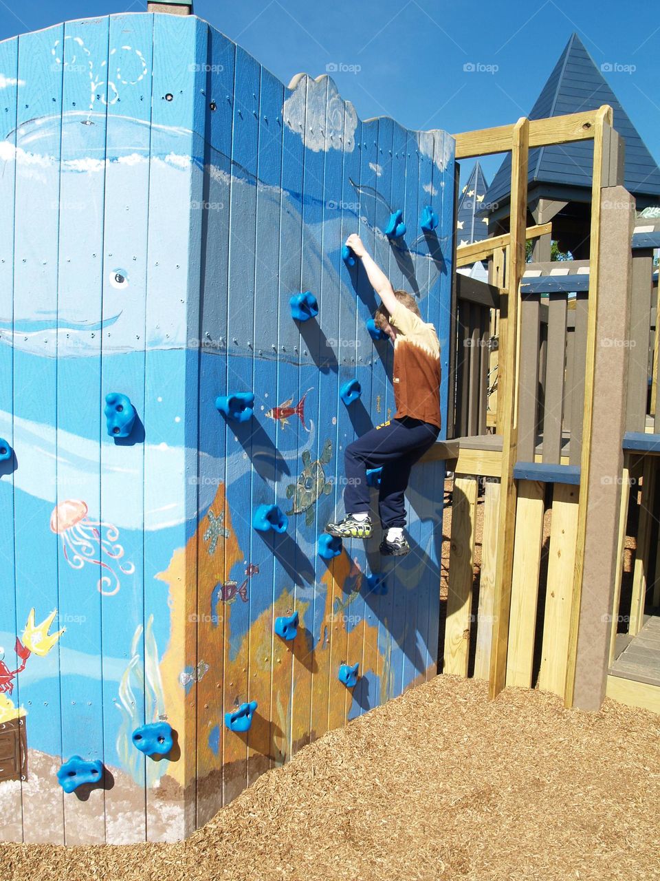 Boy climbing wall