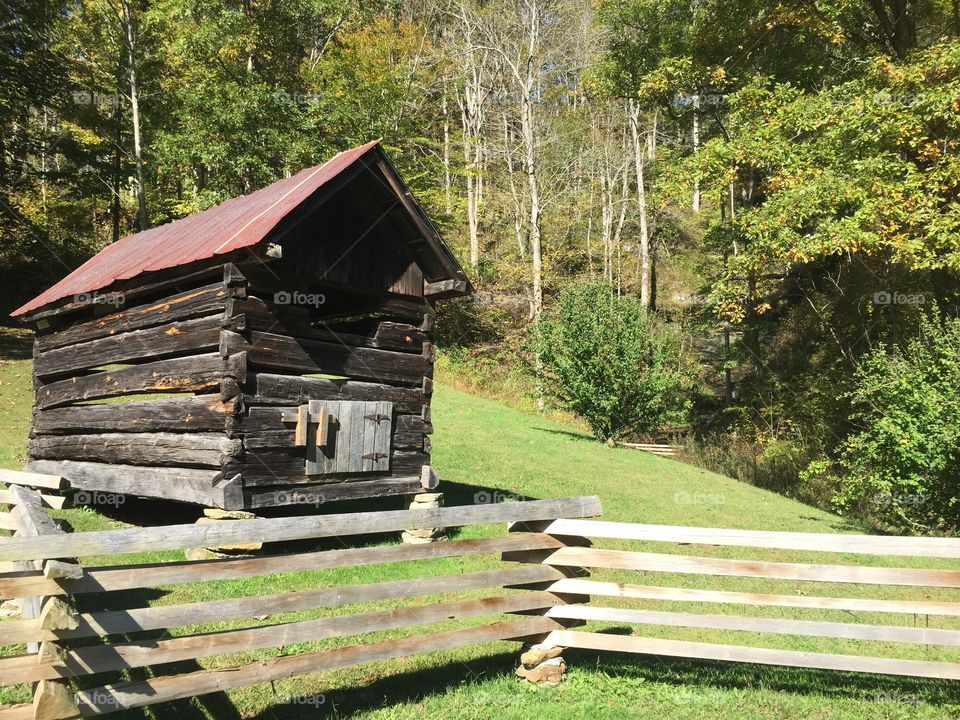 A log building on a hillside in Kentucky.