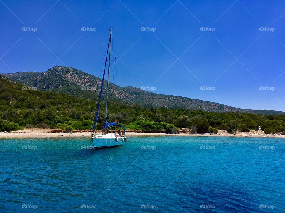 Beautiful Turkish beach with yacht at the shore