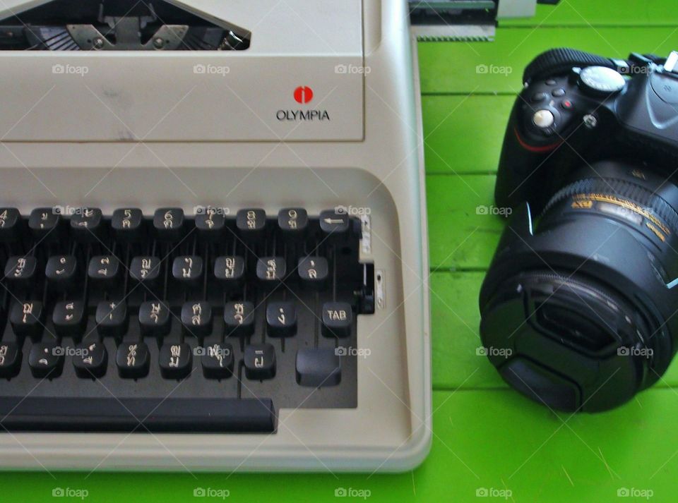 Typewriter and camera on the wooden table