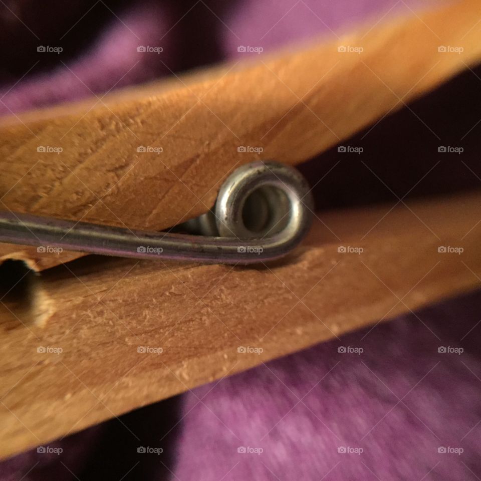 A macro view of the spring on a clothespin.