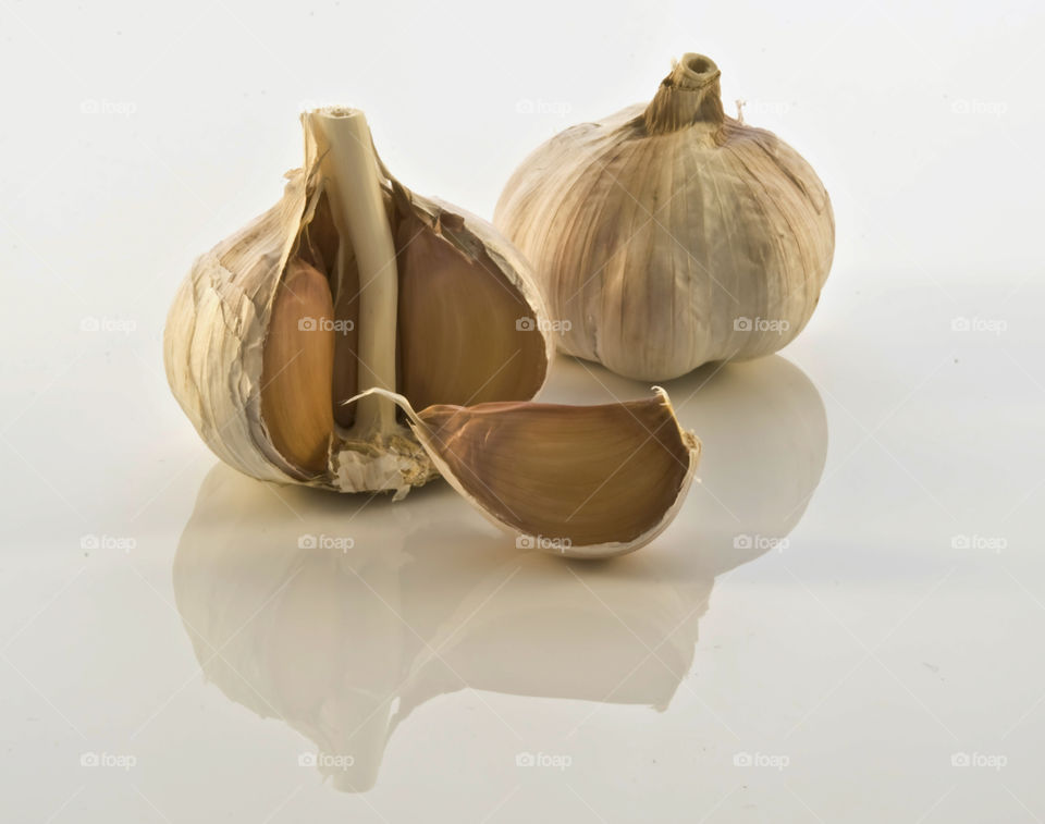 Garlic and clove on white background