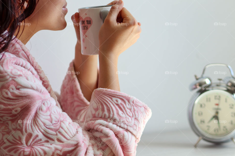 First cup of morning coffee in a woman's hands