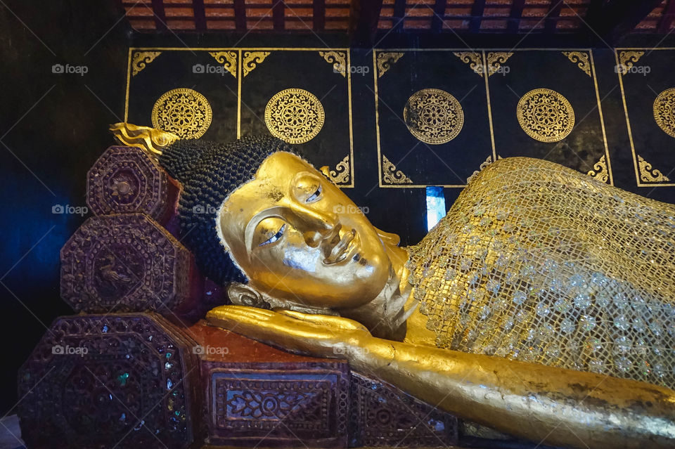 Gorgeous large gold reclining Buddha at Wat Chedi Luang in Chiang Mai, Thailand 