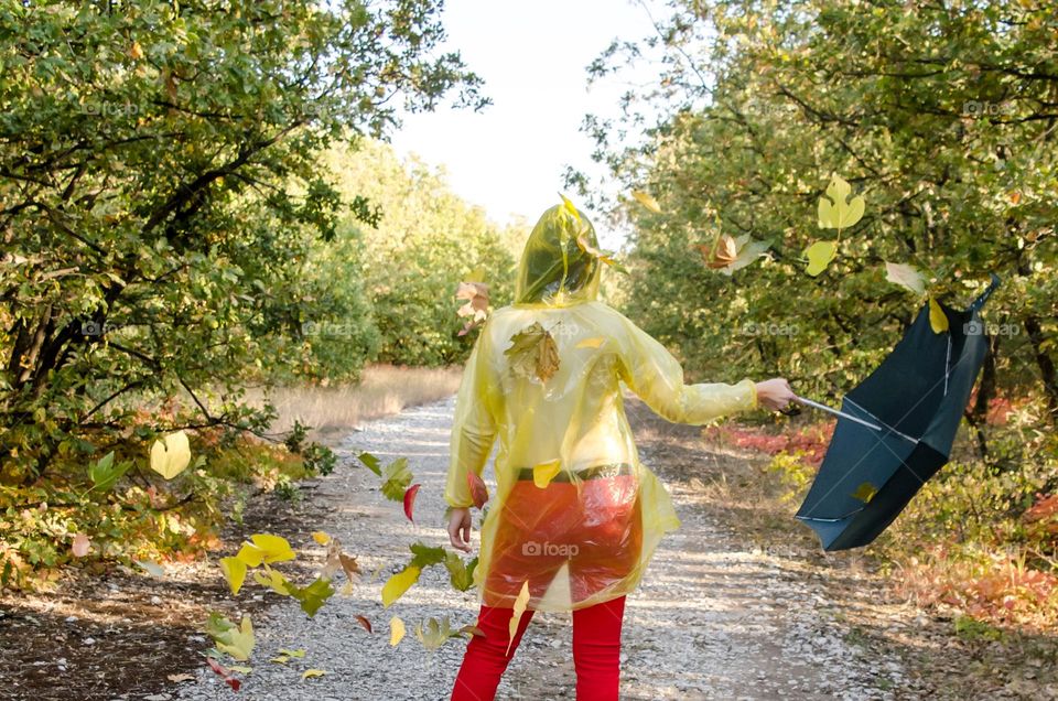 Woman with umbrella on autumn background