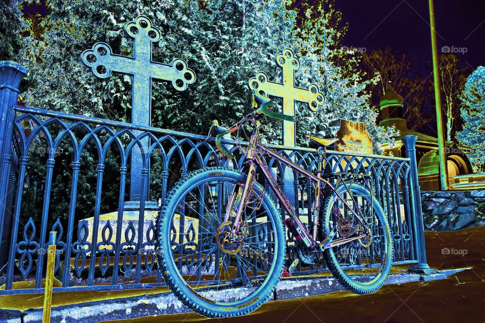 Bike in the graveyard. Touring bike in the cemetery in Helsinki,  Finland on winter evening