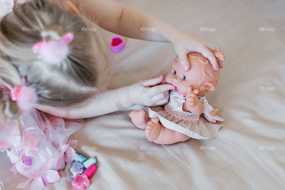 girl playing with dolls