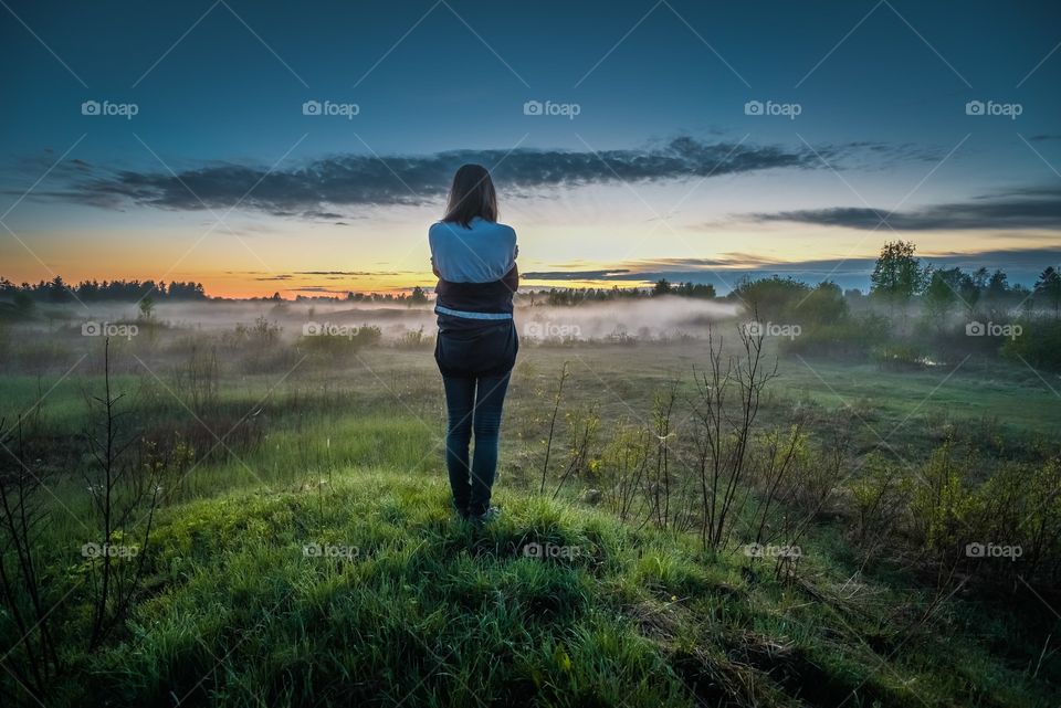Silhouette of a girl against a nature background.