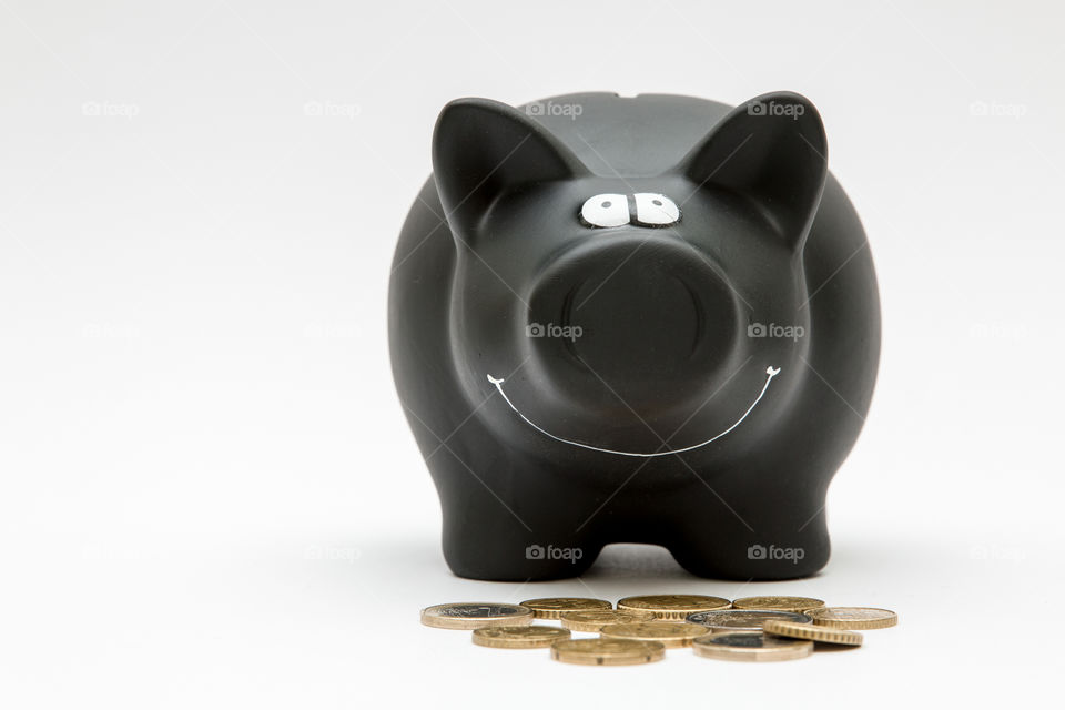 Black Piggy Bank With Coins, Isolated In White Backgound
