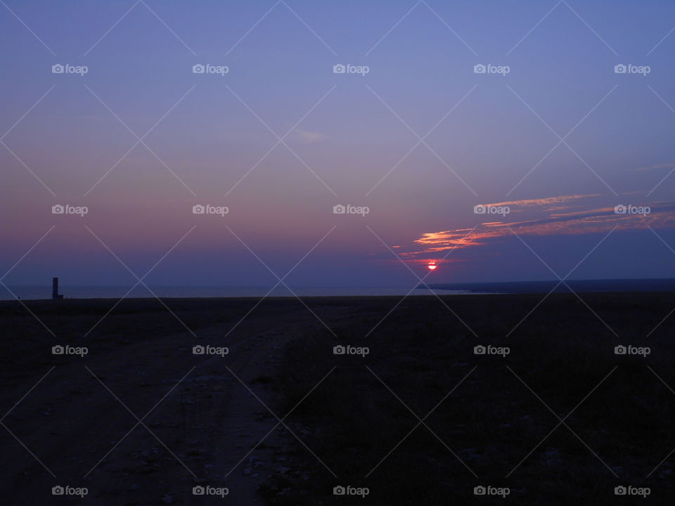 beautiful colorful sunset in the steppe and sea shore summer landscape