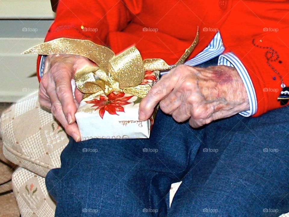 90 Year Old Mom savoring opening Christmas gift