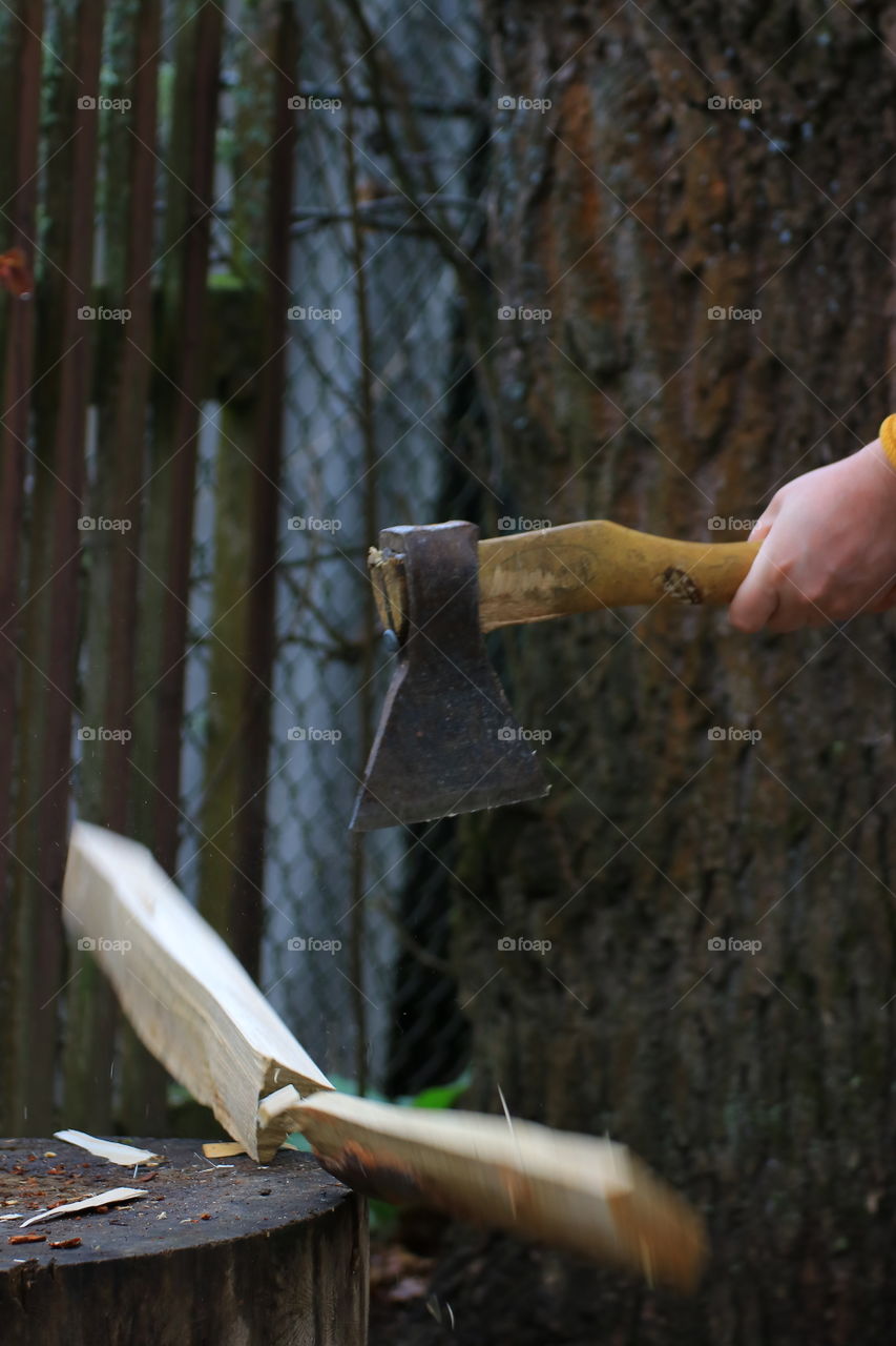 Ax.  Village.  Chop wood.  Country life.  Man's hands.