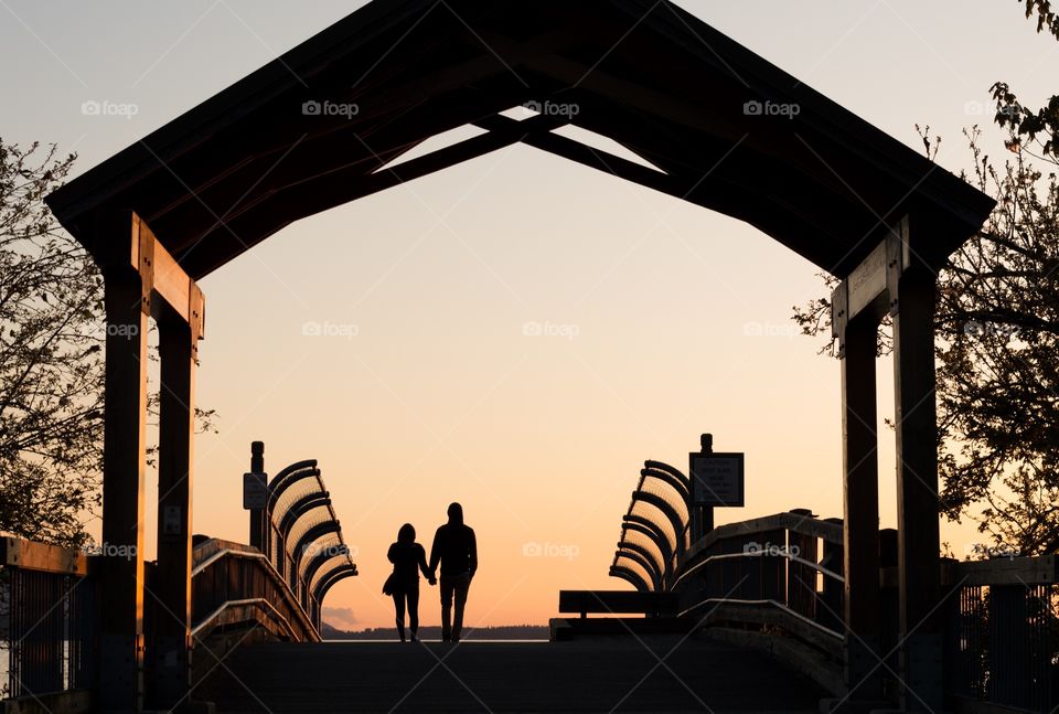 Sunset walk. A couple walking into the sunset