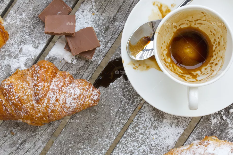 Empty cup after coffee on a wooden surface.