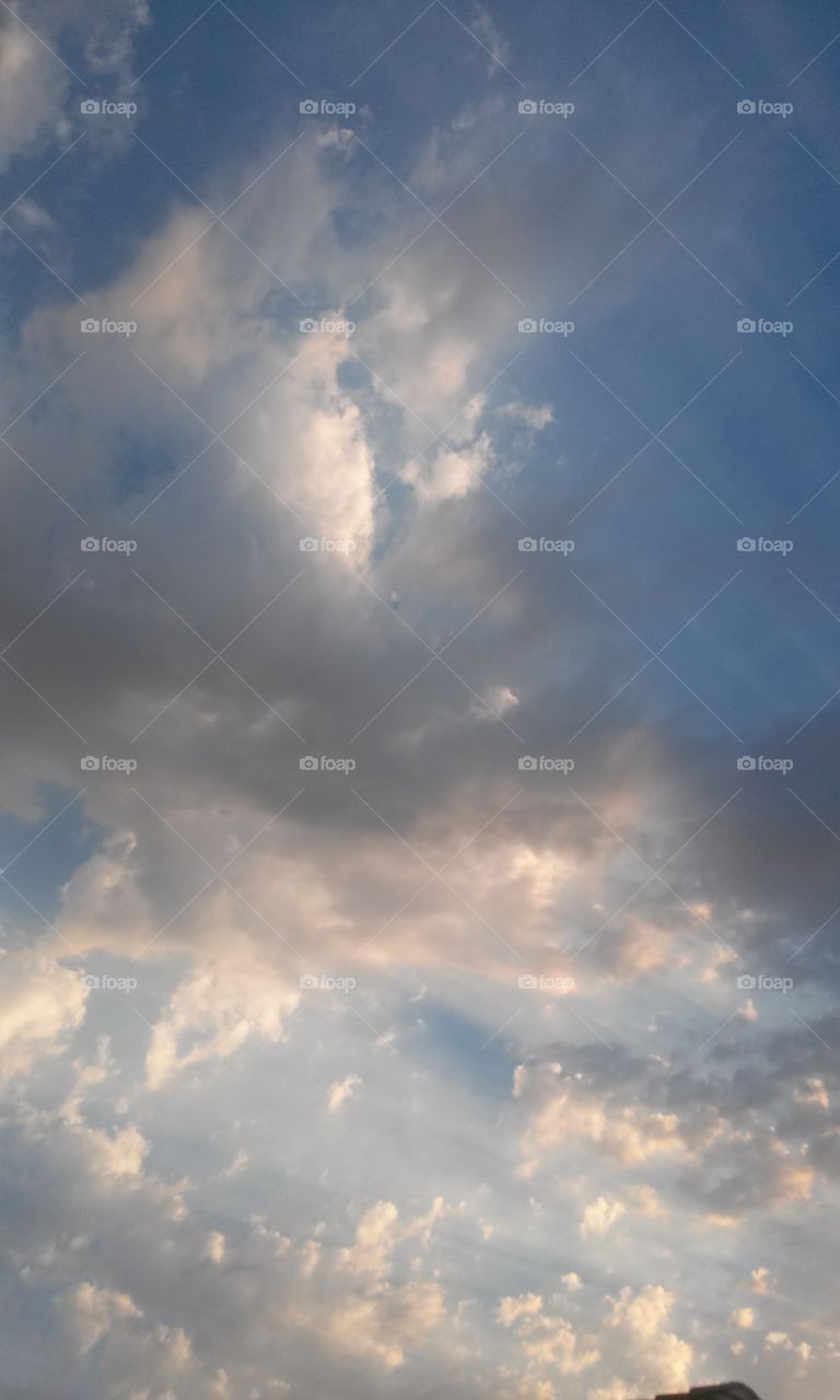 Amazing Feathery Clouds 
Colors Mixed through out 
Can you see what i see 
Faces of men , with animal 
faces mixed within . 
Telling a picture , maybe story
We can see if we just 
Look , closely within .
