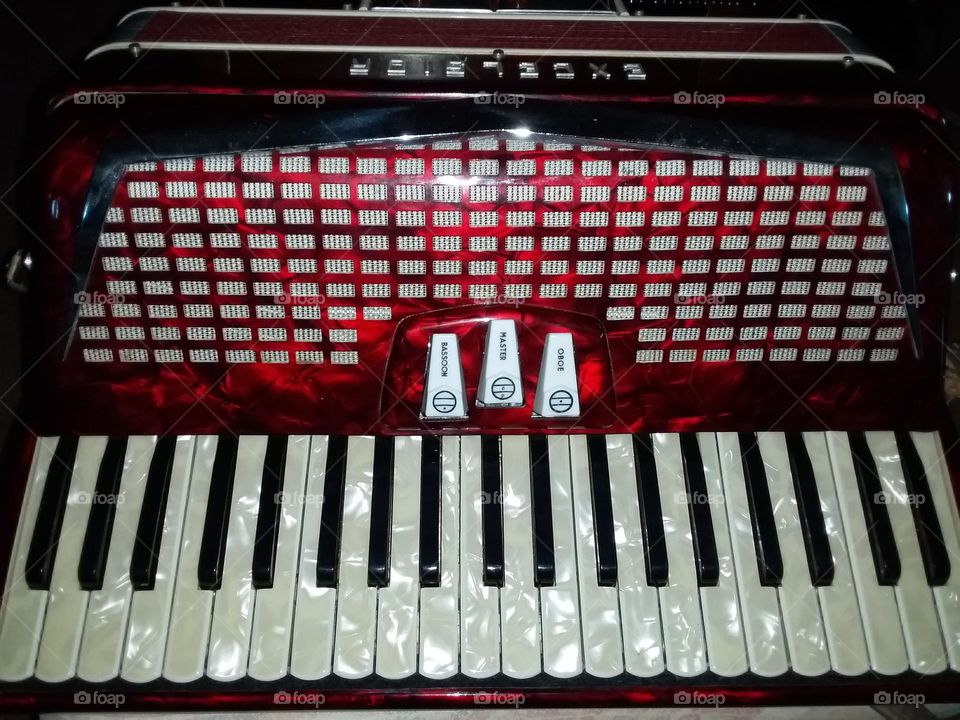shiny red and silver Excelsior piano accordion with pearl keys