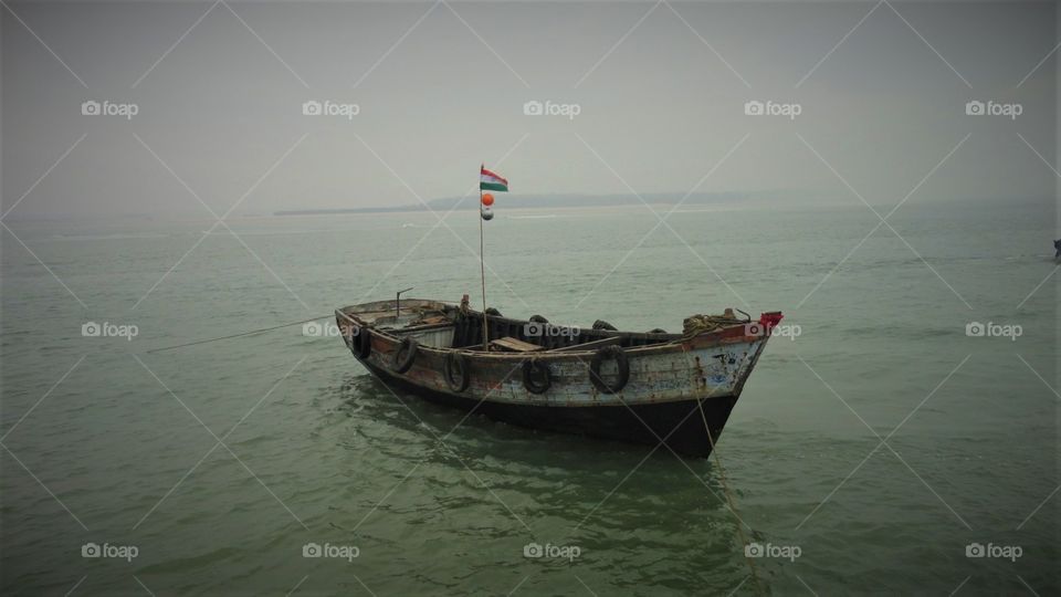 The boat is safer anchored at the port, but that's not the aim of boats. The Indian flag is a symbol of our national Unity. The boat alone is carrying peace and Harmony.This is what I felt while taking this photo.
