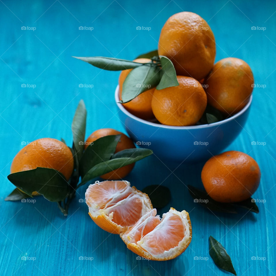 Bowl of tangerines on wooden table