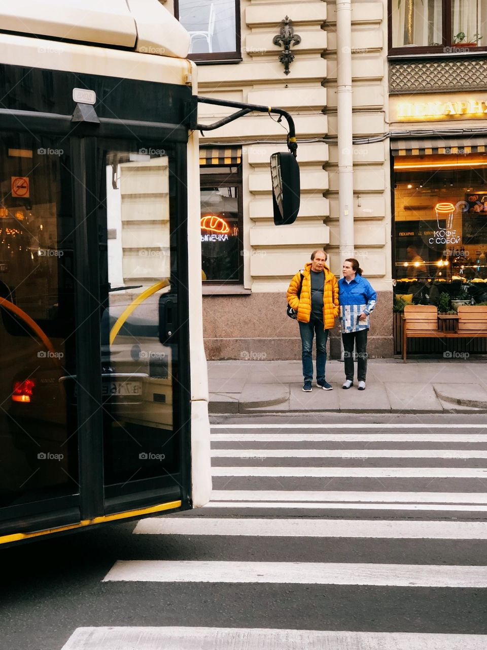 Adult couple standing in the street near streetcar