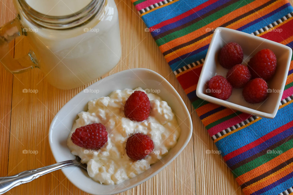 Cold glass of milk with fruit and cottage cheese